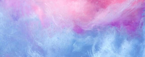 An up-close photo of cotton candy. Pink is on the top and blue is on the bottom.